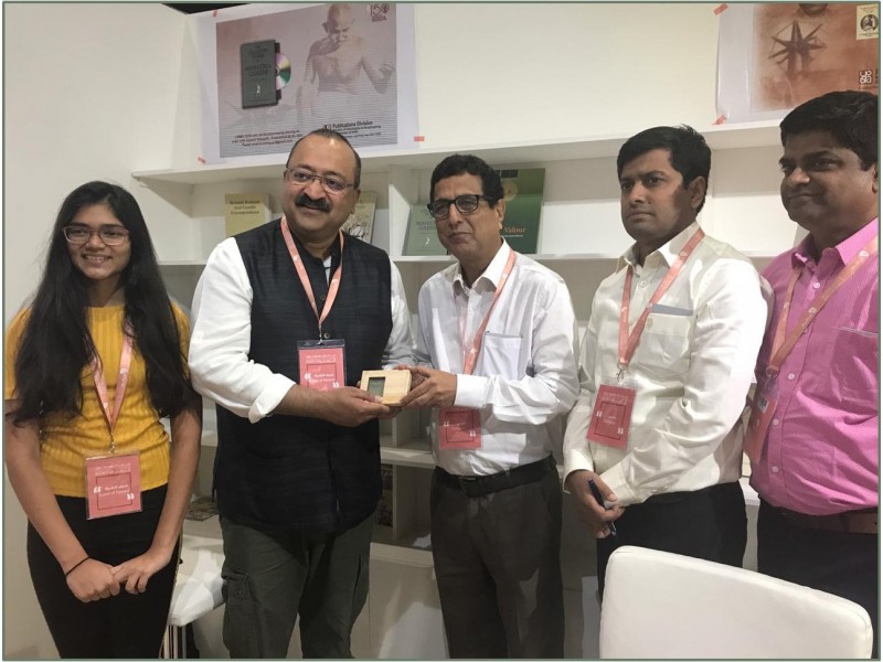 Delegation from Ministry of Information and Broadcasting presenting the pendrive of ebook of 100 volumes of The Collected Works of Mahatma Gandhi brought out by Publications Division to Birad Rajaram Yajnik famous author and curator at Abu Dhabi International Book Fair 2019